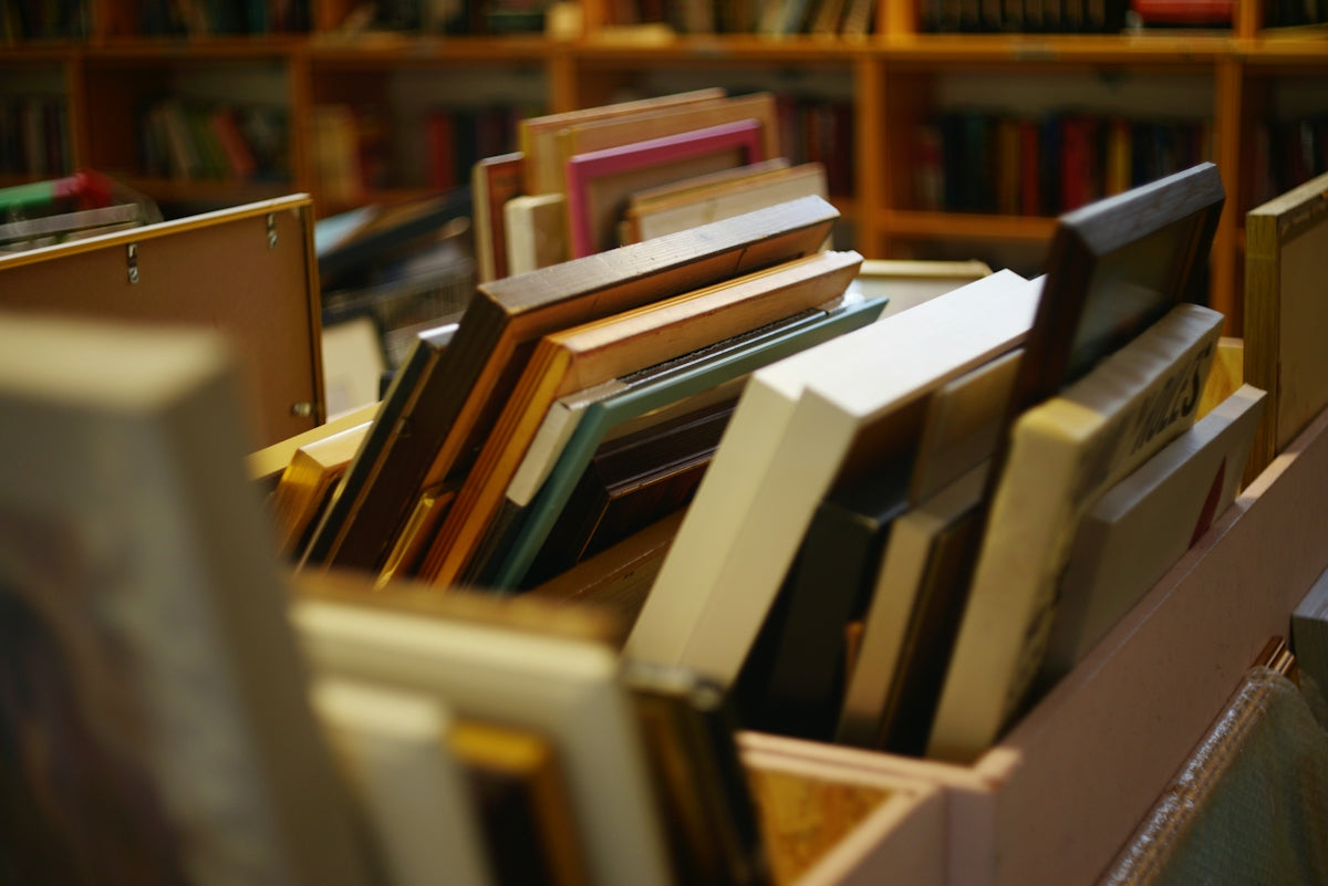 A box filled with assorted picture frames in a store
